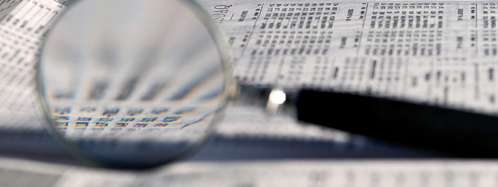 A newspaper page through the lens of a magnifying glass