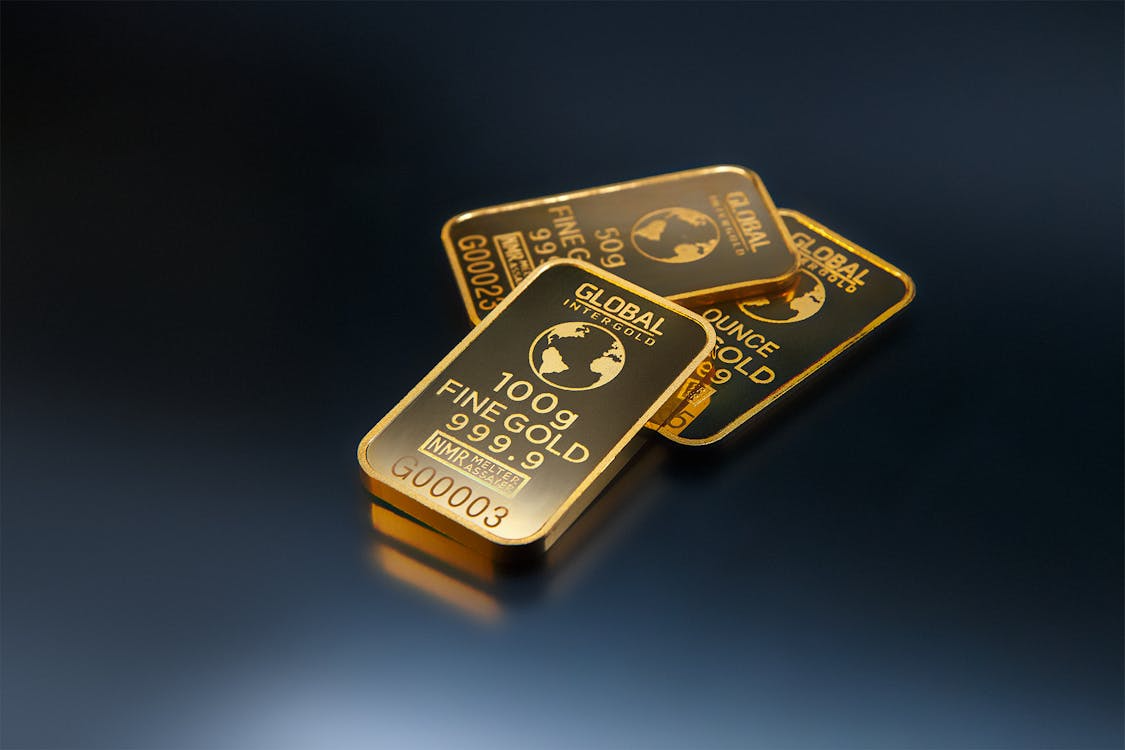 Three gold bars on a dark background